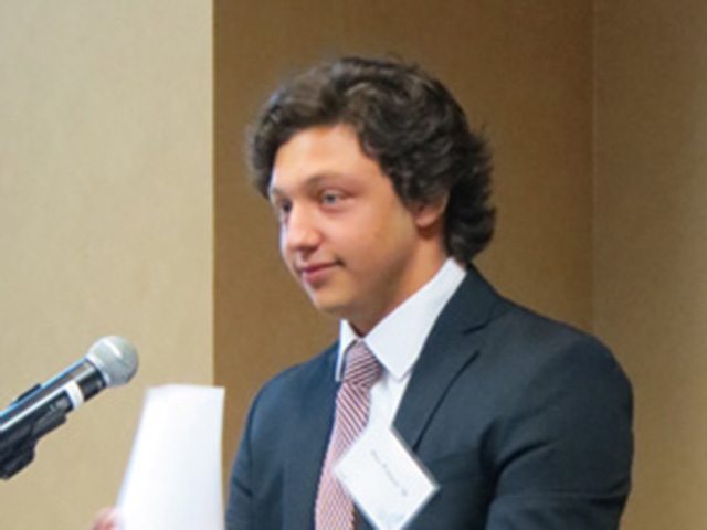 Student in suit standing at speech podium